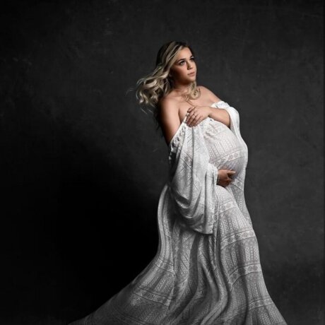 Side Pose Of Pregnant woman wearing boho maternity gown