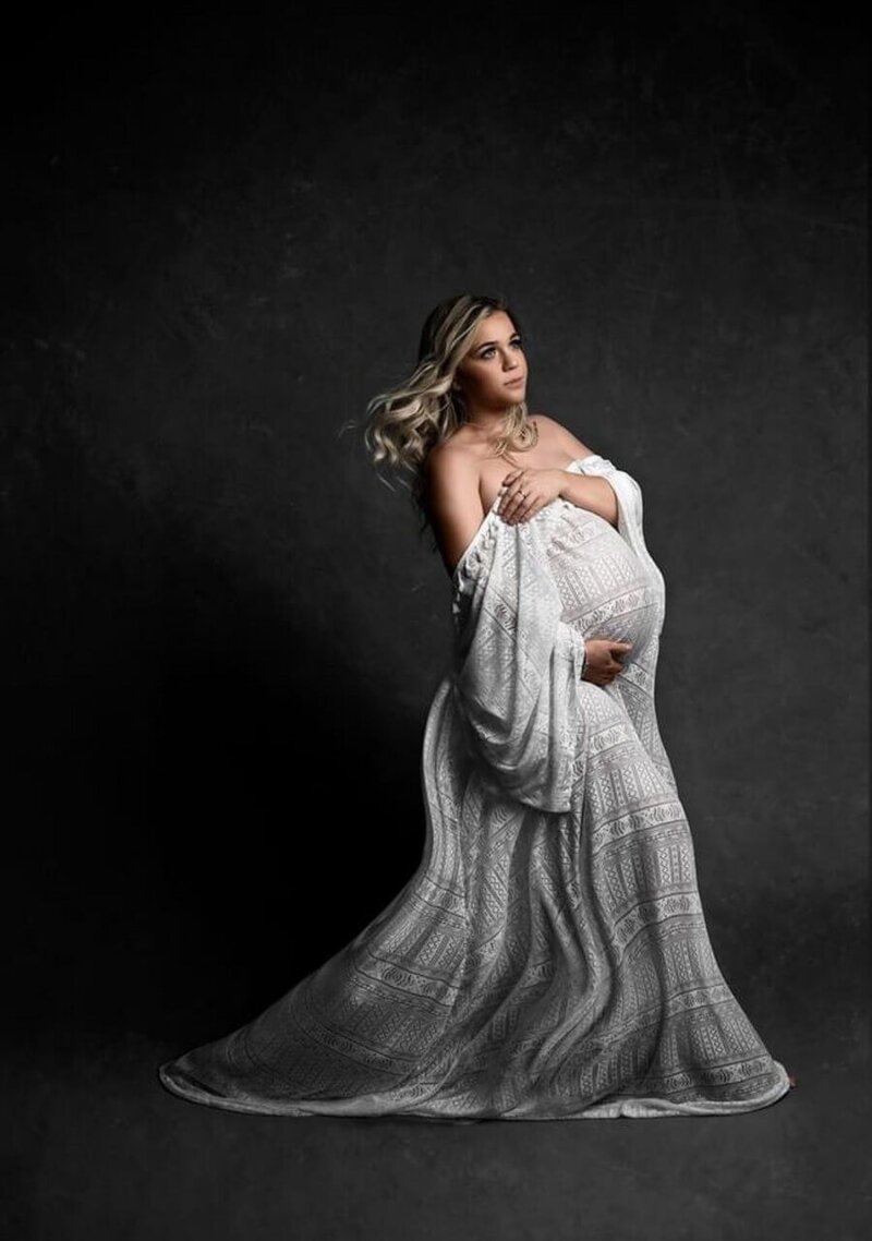 Side Pose Of Pregnant woman wearing boho maternity gown