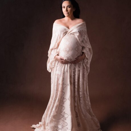 Pregnant woman wearing rosa amour boho cream gown