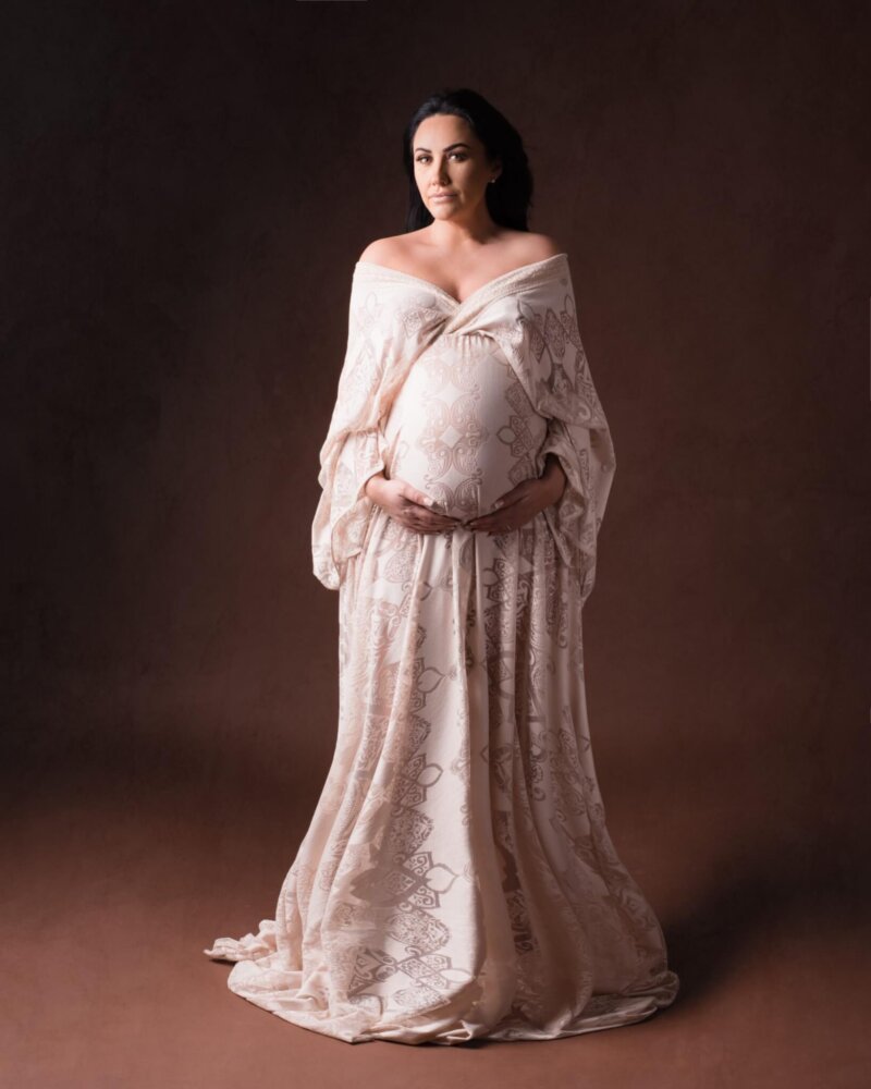 Pregnant woman wearing rosa amour boho cream gown