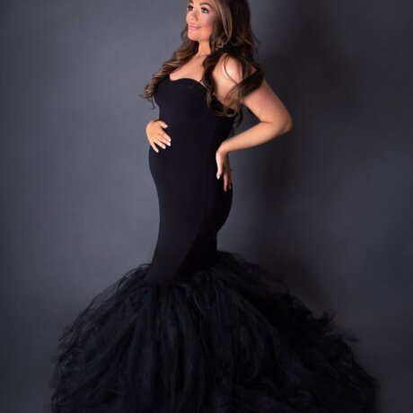 Pregnant woman wearing black ball gown by rosa amour