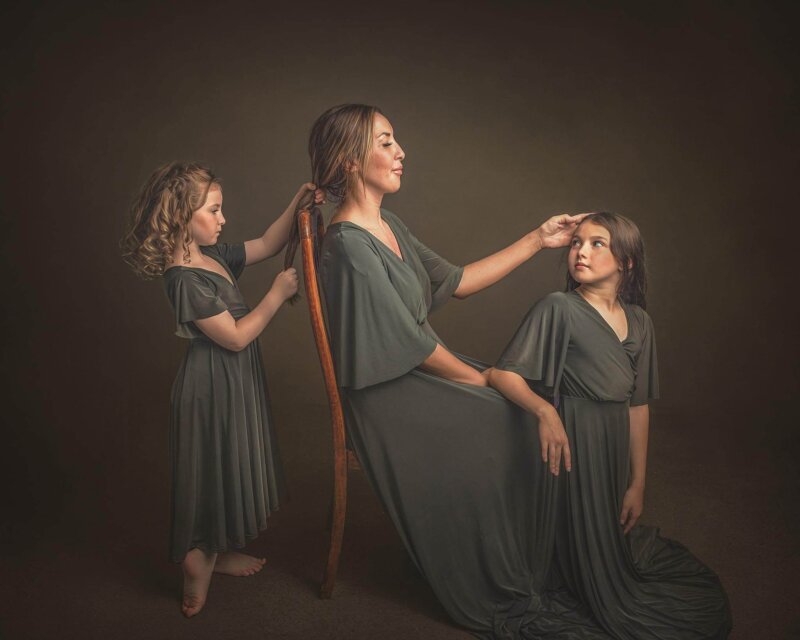 Daughters and Mother combing hearing wearing rosa amour matching gowns