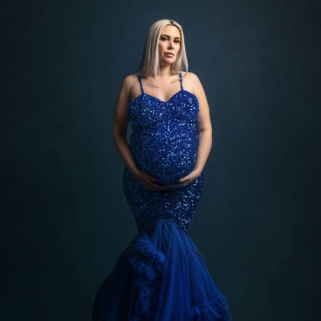 pregnant women posed wearing sequin blue dress by rosa amour
