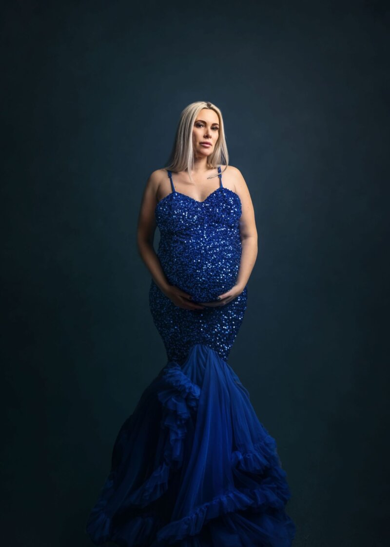 pregnant women posed wearing sequin blue dress by rosa amour