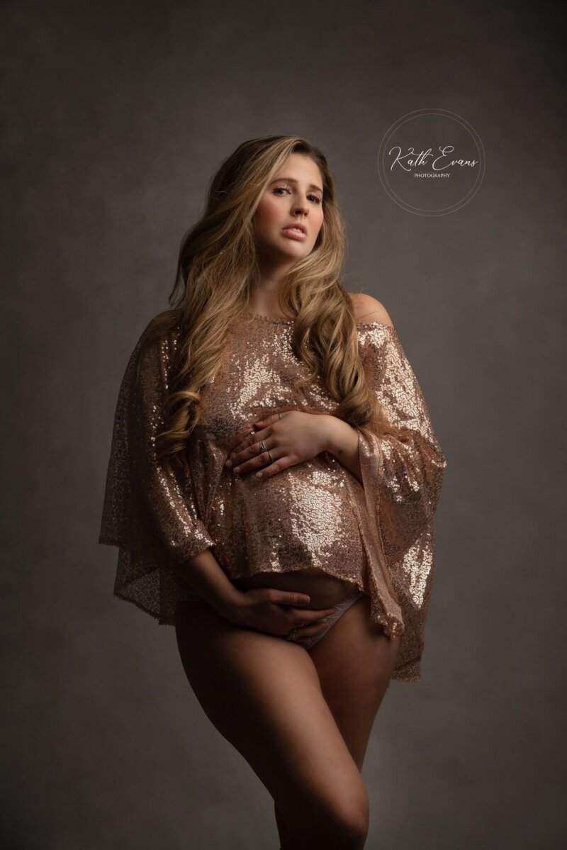 Pregnant women wearing rose pink sequin cape/shawl by Rosa Amour