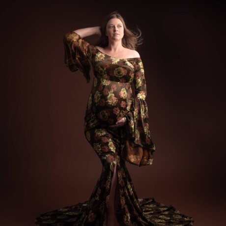 Pregnant women posed in a floral velvet dress by rosa amour