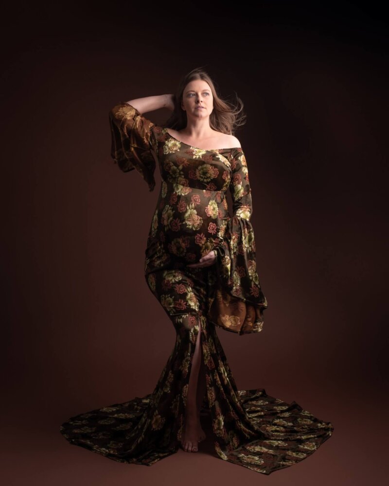 Pregnant women posed in a floral velvet dress by rosa amour