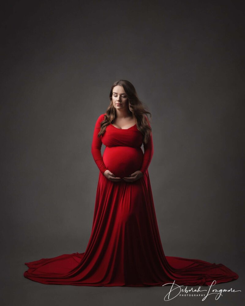 Women wearing maternity red dress by rosa amour