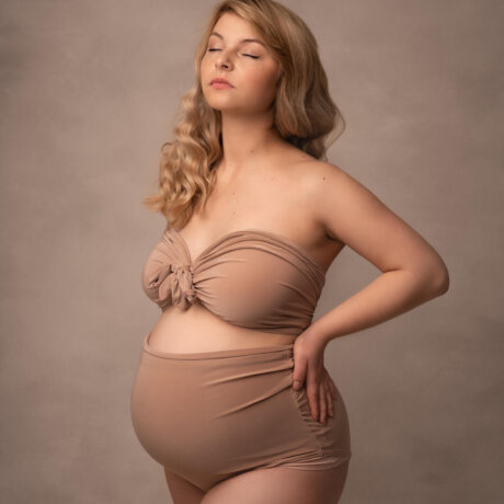 pregnant woman wearing stone bodysuit by rosa amour