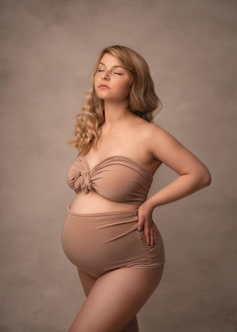 pregnant woman wearing stone bodysuit by rosa amour