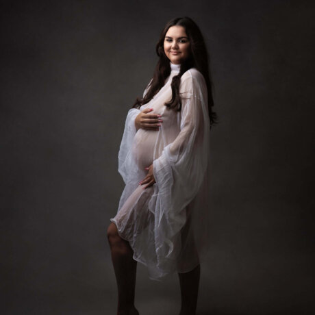 Women posed in white maternity dress by rosa amour