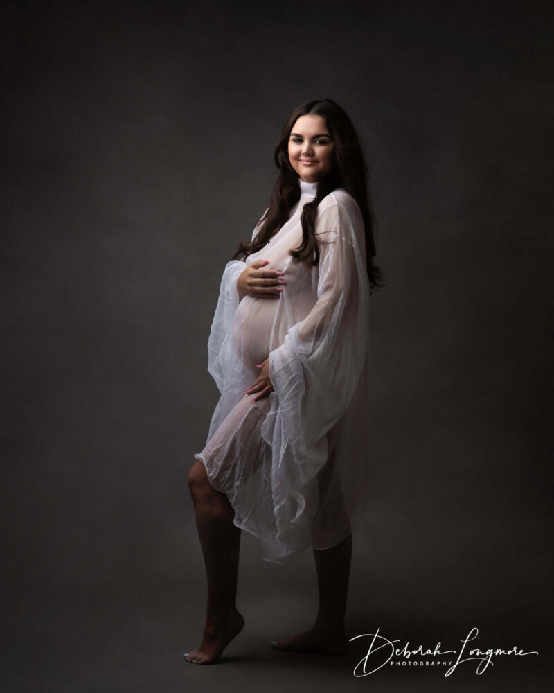 Women posed in white maternity dress by rosa amour