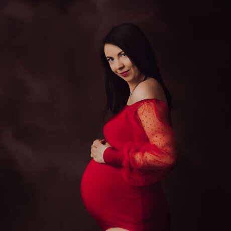side pose of pregnant lady wearing maternity red bodysuit